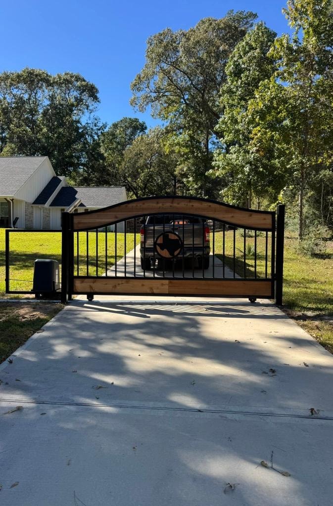 Cedar and steel sliding gate with Texas star — Access Pro Gate Company