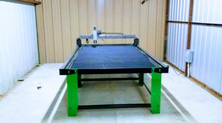 CNC plasma cutting table used to fabricate custom gate medallions and cutouts — Access Pro Gate Company shop