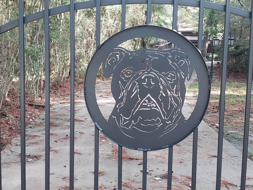 Close-up of custom bulldog medallion cut into iron gate — fabricated by Access Pro Gate Company