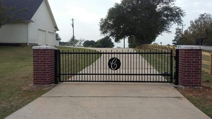 Ornamental iron driveway gate installation by Access Pro Gate Company