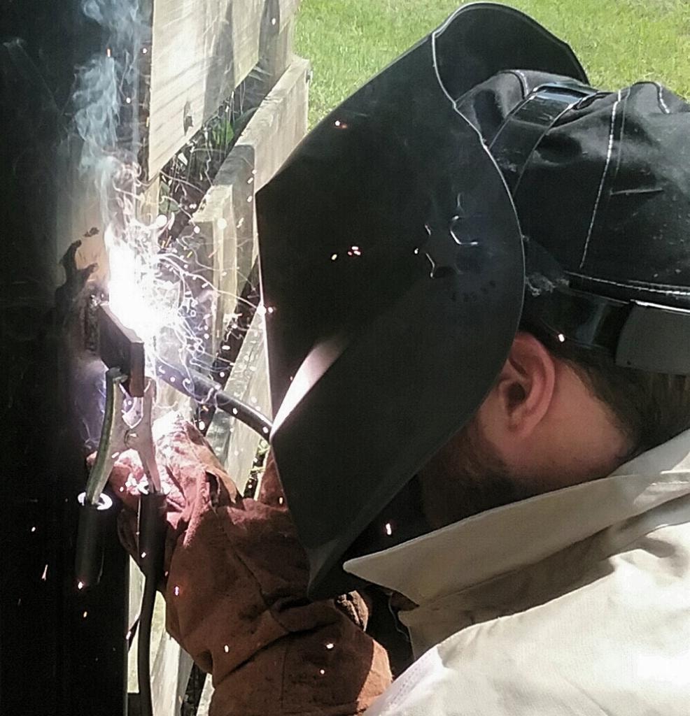 Access Pro Gate Company technician diagnosing a gate motor and control box on a job site